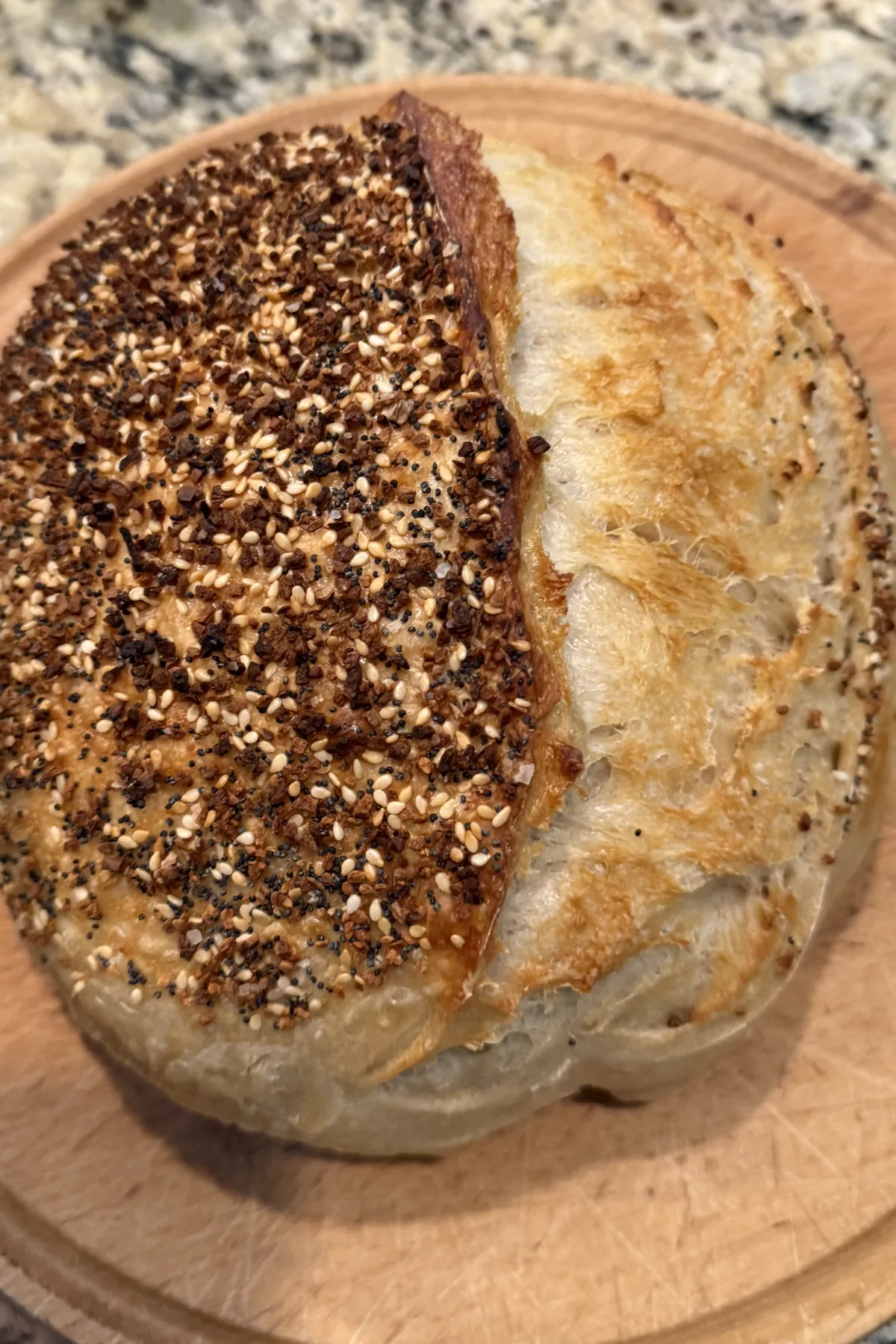 Everything-seasoned sourdough loaf on a wooden board